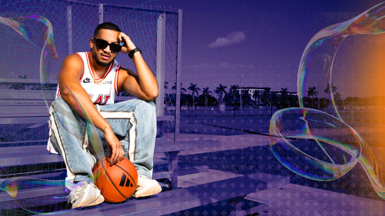 BigPickCeez sitting on the bleachers with a basketball